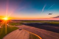 Sunset Flight  Airplane Soaring Over Airport Runway.AI Generated Royalty Free Stock Photo