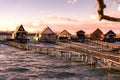 sunset on floating village bungalows in Bokod Hungary with wooden pier walkway