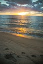 Sunset with footprints on beach