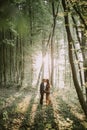 Pregnant woman and handsome man, standing face to face, walking in the forest Royalty Free Stock Photo