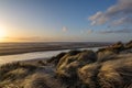 Sunset at Formby beach, with marram grass in the foreground Royalty Free Stock Photo