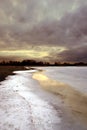 Sunset by a frozen lake