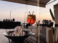 Sunset Glass of strawberry water with ice and icecream on woodentable at beach restoran view from glass door modern architecture