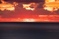 Sunset goes down over horizon in tropical sea with cloudy Royalty Free Stock Photo