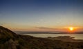 Sunset in the golden sunlight over a mountain lake