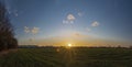 Sunset on green field near shops and markets in Budweis city