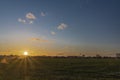 Sunset on green field near shops and markets in Budweis city