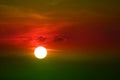 sunset on green red orange sky back soft evening cloud over space1 Royalty Free Stock Photo