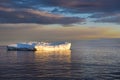 Sunset with shiny iceberg, reflecting in Arctic Ocean Iceberg, Greenland