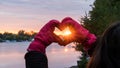 Sunset hands making heart shape in autumn or winter Royalty Free Stock Photo