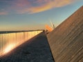 Sunset in harbor  Promenade pier   and sea water wave reflection people walk and relax modern urban  architecture por Royalty Free Stock Photo