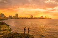 Sunset in Havana with fishermen on the foreground Royalty Free Stock Photo