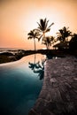 Sunset in Hawaii with blue infinity pool overlooking ocean Royalty Free Stock Photo