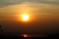 Sunset in an hazy sky and sun reflection in a lake Royalty Free Stock Photo