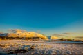 Sunset at Henningsvaer town with small wooden houses in the horizont on Lofoten Islands, Austvagoya