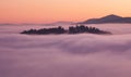 Sunset hidden behind clouds and fog over hills, bright yellow sun on colorful cloudscape, blue violet orange sky Royalty Free Stock Photo