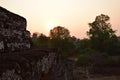 Sunset at historic angkor wat temple in cambodia with trees in background