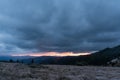 Sunset in the hungry mountains. Large thundercloud in the mountains. Glow in the mountains Royalty Free Stock Photo