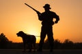 Sunset of hunter with a dog