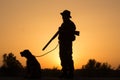 Sunset of hunter with a dog