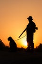 Sunset of hunter with a dog