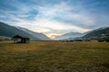 Sunset and illuminated meadow in a valley in Austria Royalty Free Stock Photo