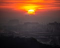 Sunset in Islamabad, Pakistan with birds flying across the horizon