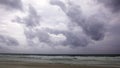 Sunset on Karon beach. Heavy clouds over the sea. The surf pounds the shore. Phuket, Thailand