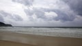 Sunset on Karon beach. Heavy clouds over the sea. The surf pounds the shore. Phuket, Thailand