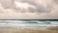 Sunset on Karon beach. Heavy clouds over the sea. The surf pounds the shore. Phuket, Thailand