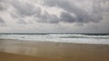 Sunset on Karon beach. Heavy clouds over the sea. The surf pounds the shore. Phuket, Thailand