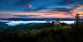 Sunset in Kasperk castle, Sumava, Czech Republic. Cold day in Sumava National park, hills and villages in the fog, misty view on Royalty Free Stock Photo