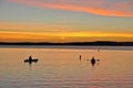 Sunset and kayakers in the bay Royalty Free Stock Photo