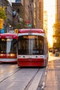 Sunset on King Street with a 503 Kingston Rd to Spadina streetcar and 504 King to Distillery passing Royalty Free Stock Photo