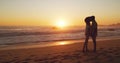 Sunset, kiss and silhouette of couple at the beach for bonding, date or holiday in Bali. Care, dark and a man and woman