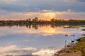 Sunset in the lake. beautiful sunset behind the clouds above the over lake landscape background. Summer