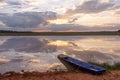 Sunset on the lake. Beautiful sunset behind the storm clouds before a thunder storm above the over lake landscape background.