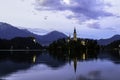 Evening sunset at Lake Bled in Slovenia. Enlightened church on the island, castle ba rock and mountains in the setting sun. Royalty Free Stock Photo