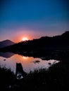 Sunset and lake with a boat and blue sky Royalty Free Stock Photo