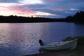 Sunset on the lake with fishing boat on the shore in Finland