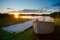 Sunset on the lake, fishing boat on the shore