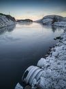 Sunset on the lake, frosted rocks and vegetation of the coast, Norway Royalty Free Stock Photo