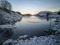 Sunset on the lake, frosted rocks and vegetation of the coast, Norway Royalty Free Stock Photo