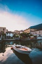 Sunset on the lake lago di garda on the coast of salo boat near the pier on the background of the old city Royalty Free Stock Photo