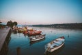 Sunset on the lake lago di garda on the coast of salo boat near the pier on the background of the old city Royalty Free Stock Photo