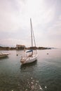 Sunset on the lake lago di garda on the coast of salo boat near the pier on the background of the old city Royalty Free Stock Photo