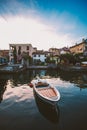 Sunset on the lake lago di garda on the coast of salo boat near the pier on the background of the old city Royalty Free Stock Photo