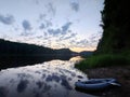 Sunset on the lake in the mountains with kayak and canoe. Beautiful sunset on the lake in the mountains.