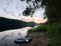 Sunset on the lake in the mountains with kayak and canoe. Beautiful sunset on the lake in the mountains.