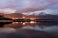 Sunset on the lake with the reflection of mountains Royalty Free Stock Photo